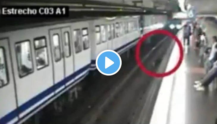 Woman falls in front of train while using phone; video will give you goosebumps!