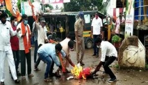 BJP workers burn effigy of Civil Supplies minister after remarks on temple attacks