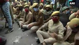Tractor Rally: Police personnel sit on road in Nangloi to block farmers' tractor rally