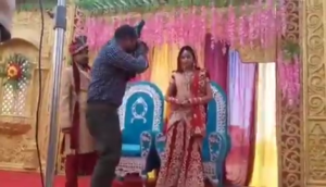 Bride gives epic reaction after groom smacks their wedding photographer