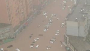 China floods: Rail stations, roads submerged; a dam 'could collapse any time'