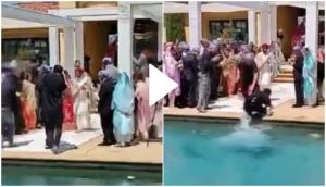 Oh No! Photographer falls into swimming pool while recording wedding ceremony; hilarious moment goes viral