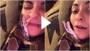 Girl chills with her pet snake, kisses on its chin; viral video will amuse you!