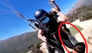 Man hangs onto paraglider mid-air without safety harness, watch nail-biting video 