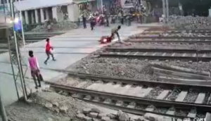 Watch: Heart-stopping video captures motorcyclist's narrow escape from train 