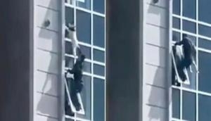 Video: Brave man risks his life to save child dangling from 8th floor  