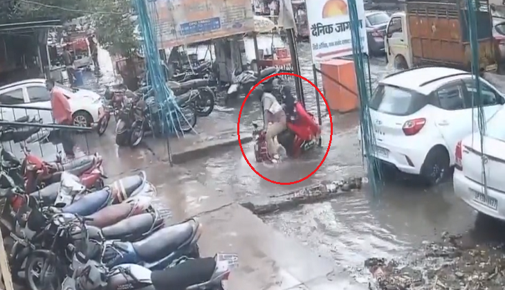 Couple on two-wheeler falls into water filled pit; shocking video goes viral