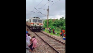 Viral Video: Woman crosses railway track to collect luggage just before speeding train arrives