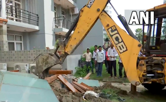 UP: Bulldozers demolish illegal construction at home of man who misbehaved with woman at Noida society