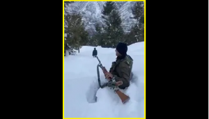 With smile on face, Indian Army jawan performs duty in sub-zero temperature; wades through waist-deep snow [WATCH] 