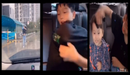 Heartwarming video of brother protecting younger sister from rain goes viral