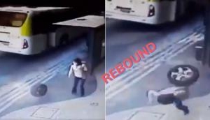 Shocking Footage: Loose Car Tyre Strikes Woman on the Rebound
