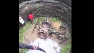 Tractor pulled out of well with two JCBs