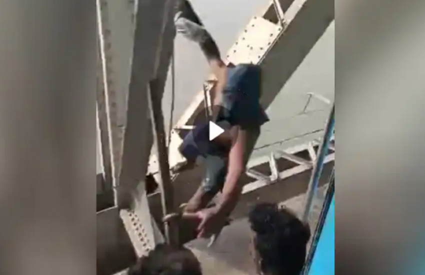 Cliffhanger Stunt: Man Hangs from Bridge, Snatches Phone from Speeding Train!