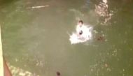 Ganesh mandal volunteer holds police man's head under water during Ganesh festival 