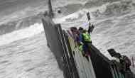 As US-Mexico border crossing shuts, asylum seekers climb 'the wall' in desperation 