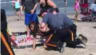 Viral Video: Cop punches girl in head and wrestles her down into sand
