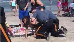 Viral Video: Cop punches girl in head and wrestles her down into sand