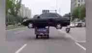 Viral Video: A rickshaw carrying black sedan car on its top and travelling on the roads of China
