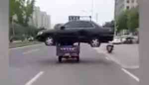 Viral Video: A rickshaw carrying black sedan car on its top and travelling on the roads of China