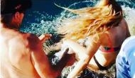 Shocking Video: Woman feeding shark gets dragged into water