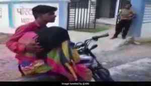 Shocking: Video of a man carrying mother's body on bike for post-mortem in Madhya Pradesh goes viral; probe ordered