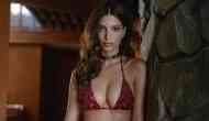 Emily Ratajkowski covers breast and flashes huge wedding ring in thong bikini