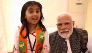 Young girl praises BJP with PM Modi by her side; Congress says poll code violation [WATCH]