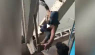Cliffhanger Stunt: Man Hangs from Bridge, Snatches Phone from Speeding Train!
